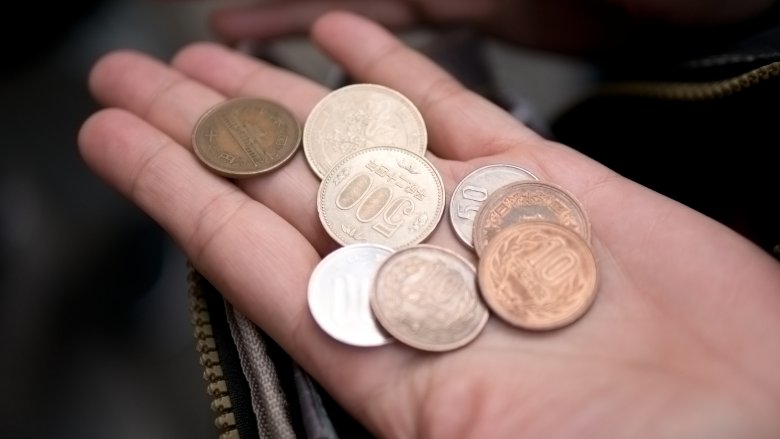 Hand with Japanese coins