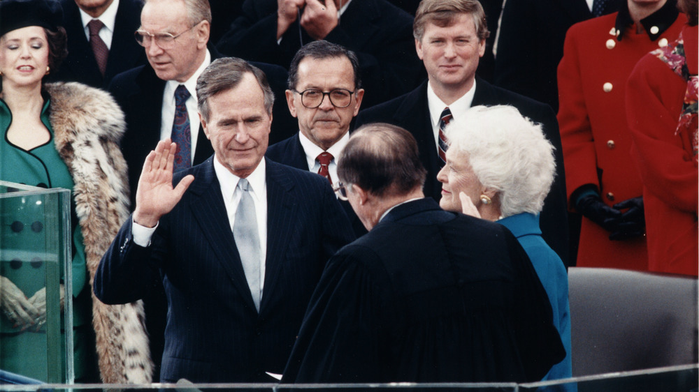 Chief Justice William Rehnquist administering the oath of office to President George H. W. Bush during Inaugural ceremonies at the United States Capitol. January 20, 1989