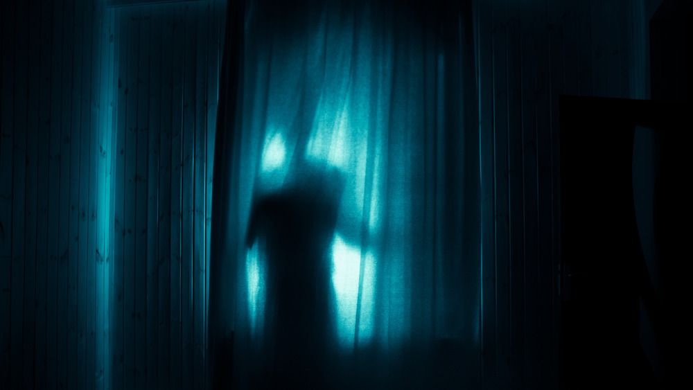 Ghostly silhouette behind a curtain