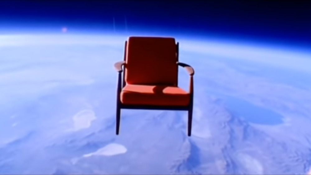 An armchair in space above the earth