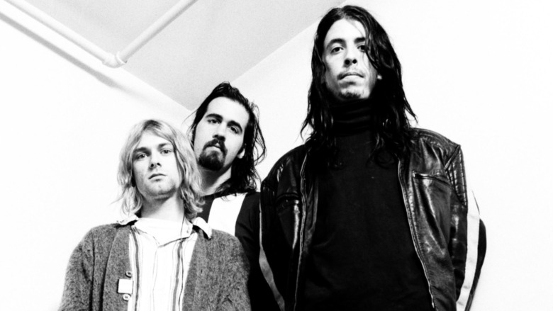 Nirvana members standing in a corner