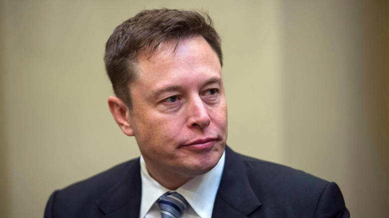Elon Musk in a black suit