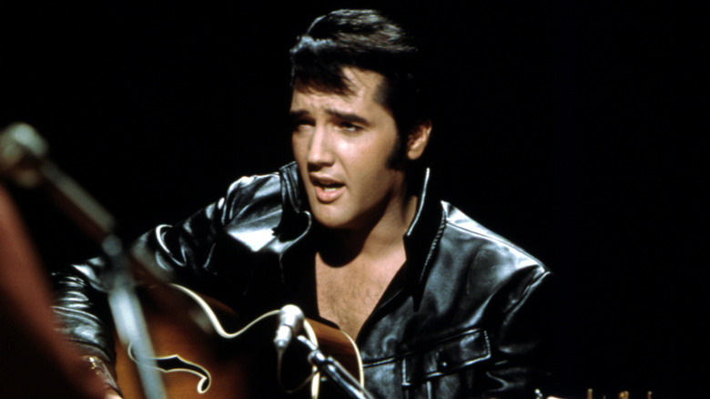 Elvis Presley performing with guitar