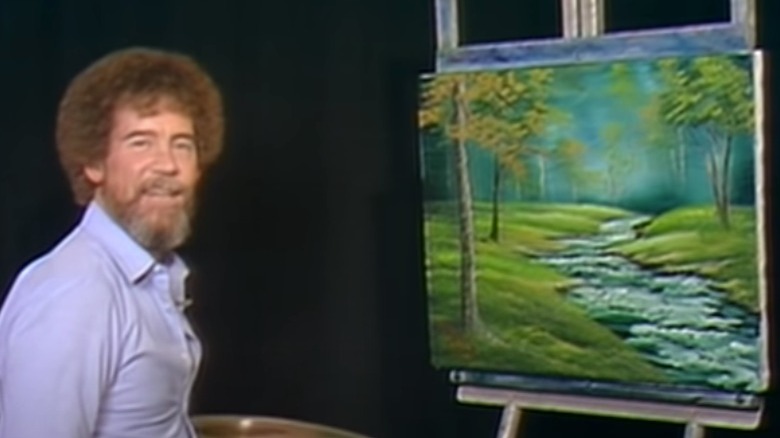 Bob Ross smiling with finished painting