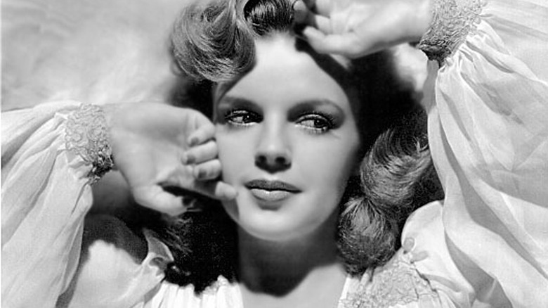 Judy Garland posing with hands up to her face