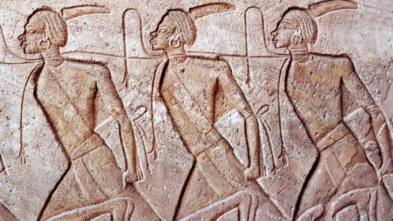 Images of Ancient Egyptian prisoners carved into a wall 