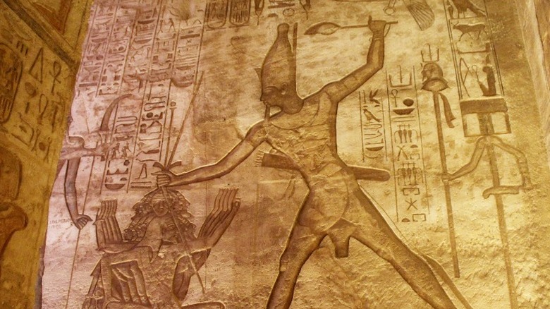 A carving of an ancient Egyptian pharaoh executing a person  