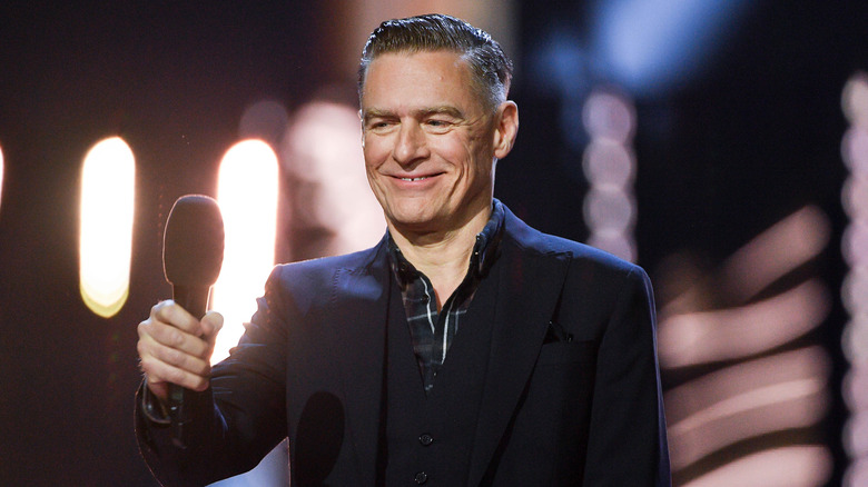 Bryan Adams smiling in a candid photo