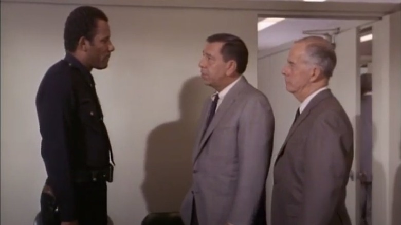 Friday and Gannon consult with a uniformed officer on a 1967 episode of 