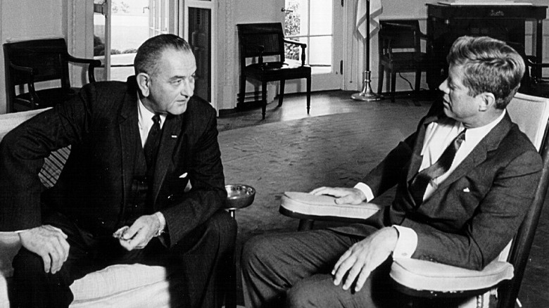 John F. Kennedy sitting with Lyndon B. Johnson