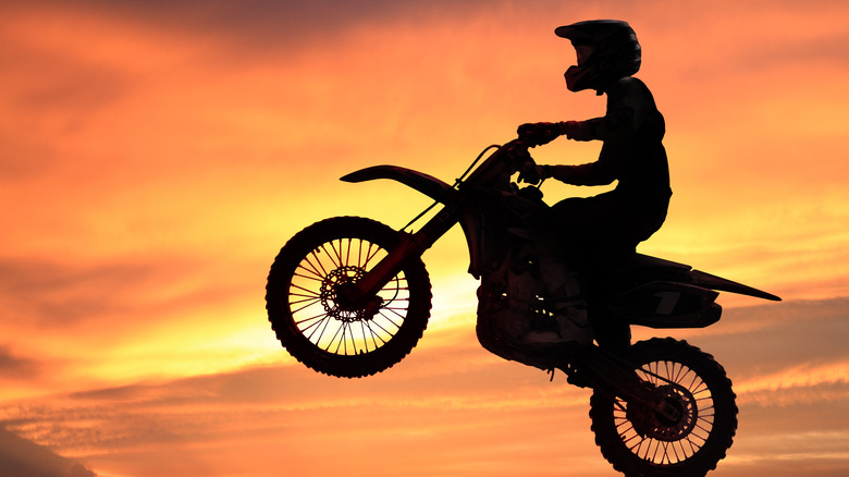 Motorcycle jumping in the sunset