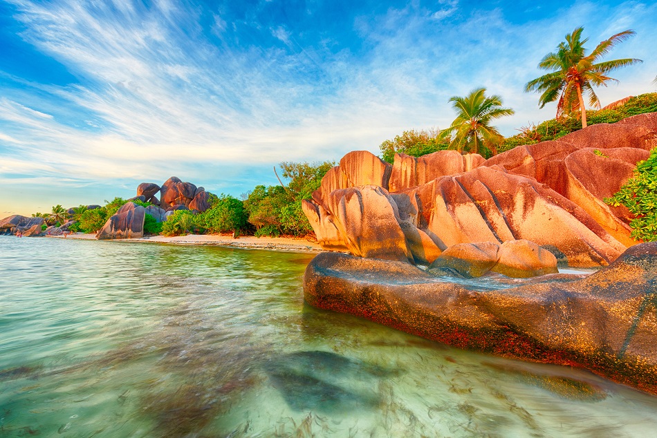 Beautifully shaped granite boulders and a dramatic sunset at Anse Source d'Argent beach, La Digue island, Seychelles