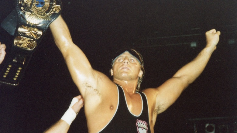 Owen Hart with  hands raised