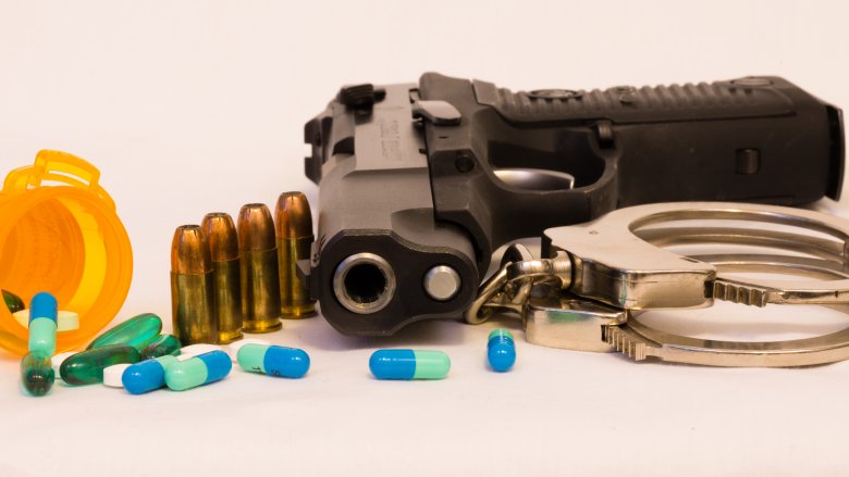 Gun, handcuffs and prescription pills