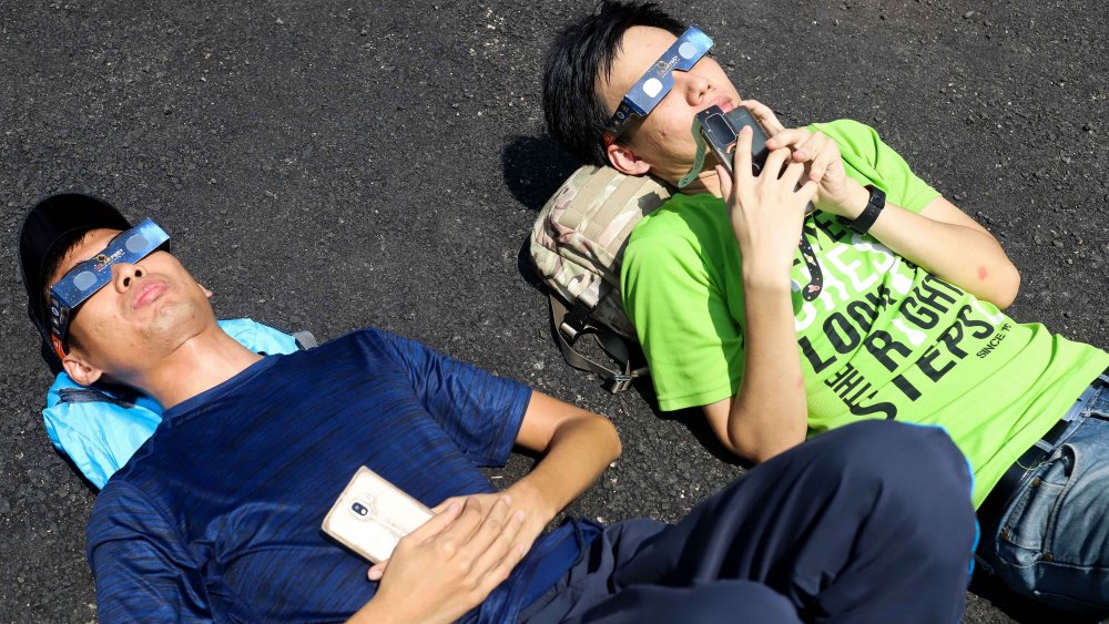 two men watching eclipse