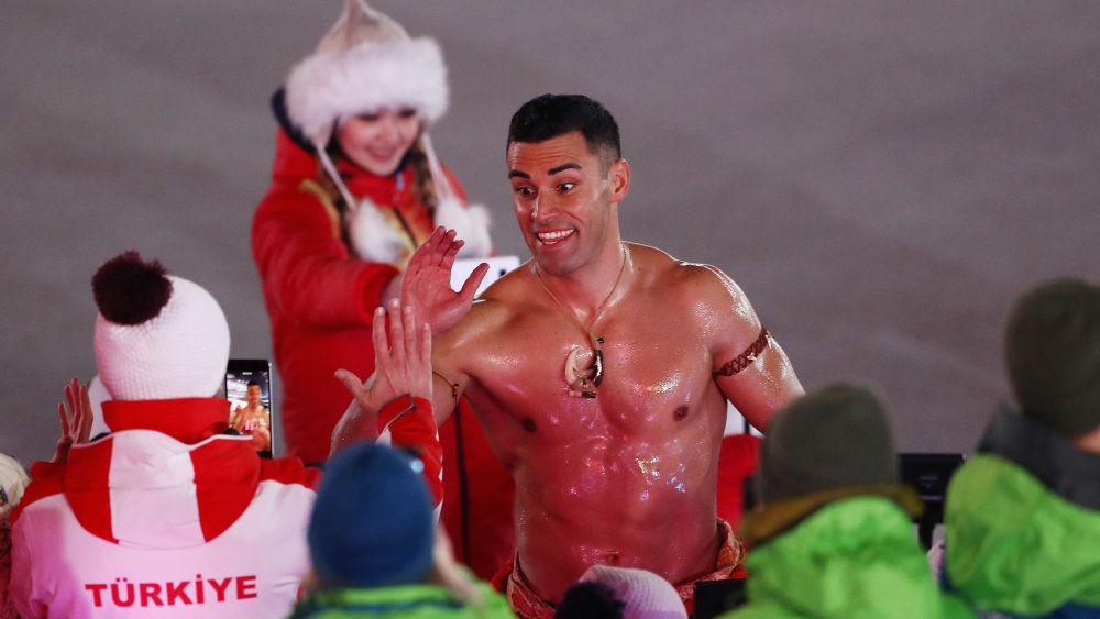 Shirtless Tongan high five at 2018 Winter Games