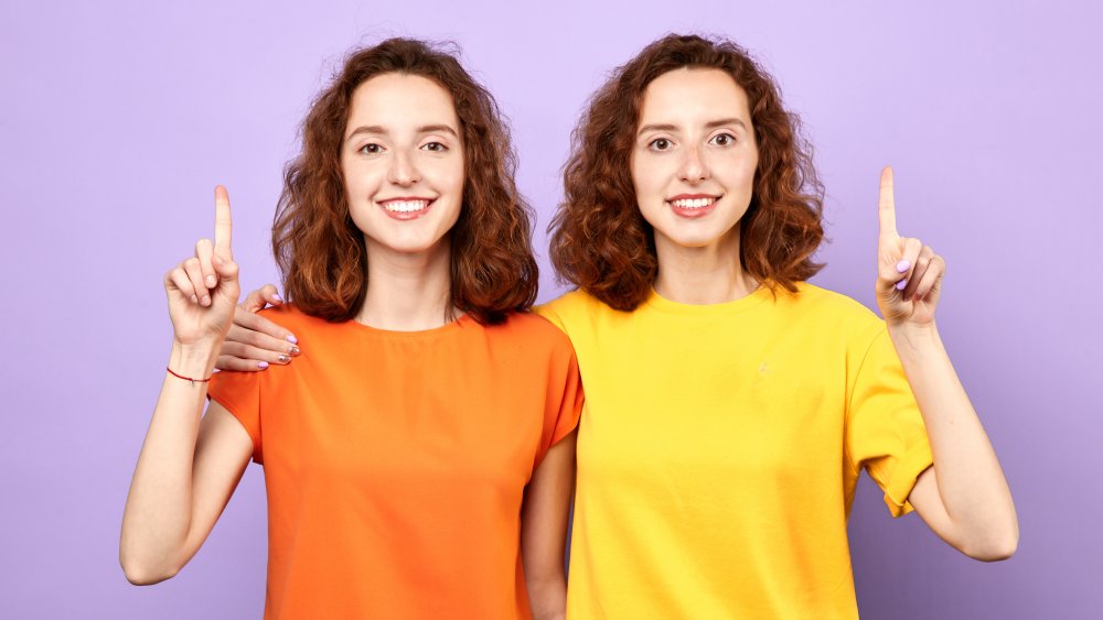 Twins wearing different color shirts