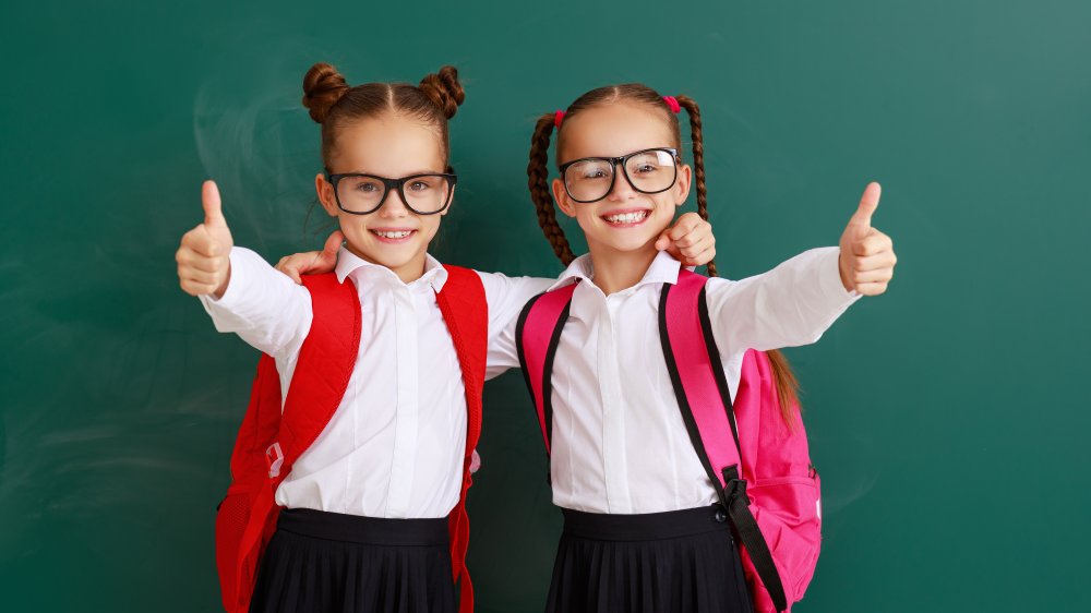 Twins in front of a chalkboard