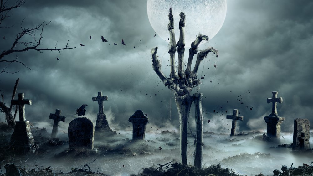 Skeleton hand in graveyard