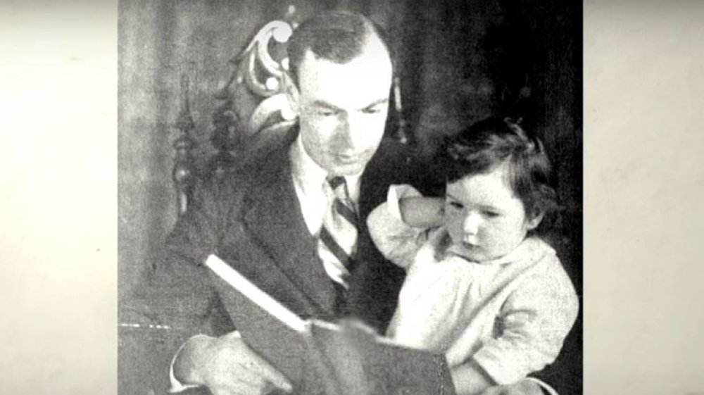 Barbara and her father reading a book to her