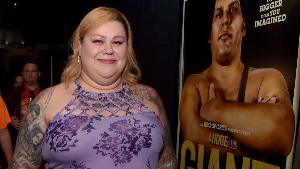 Robin Christensen-Roussimoff, Andre The Giant's daughter posing next to a poster of her father