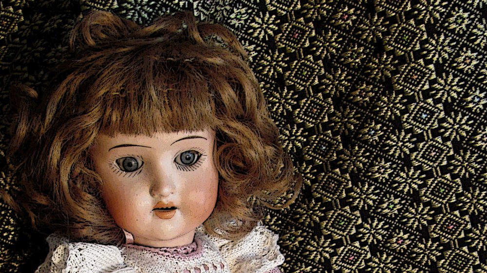 Porcelain bisque doll in dress