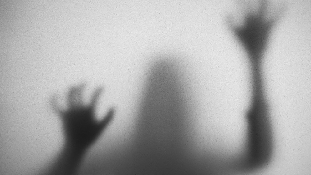 An image of a silhouette in a haunted house like setting