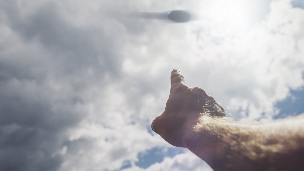 A hand pointing to a UFO