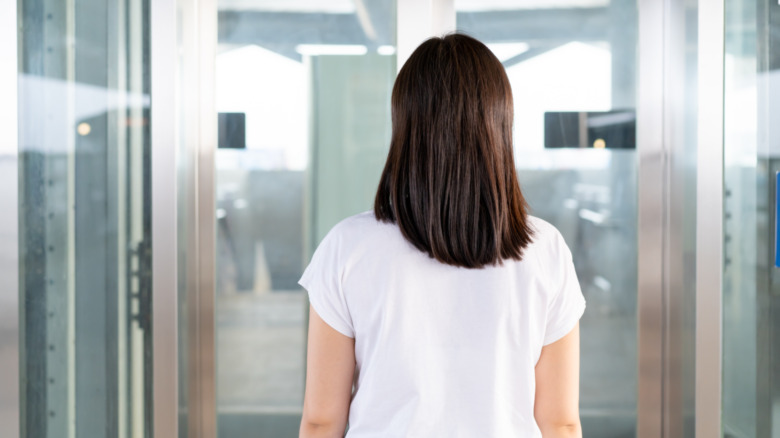 woman standing in front of an elevator