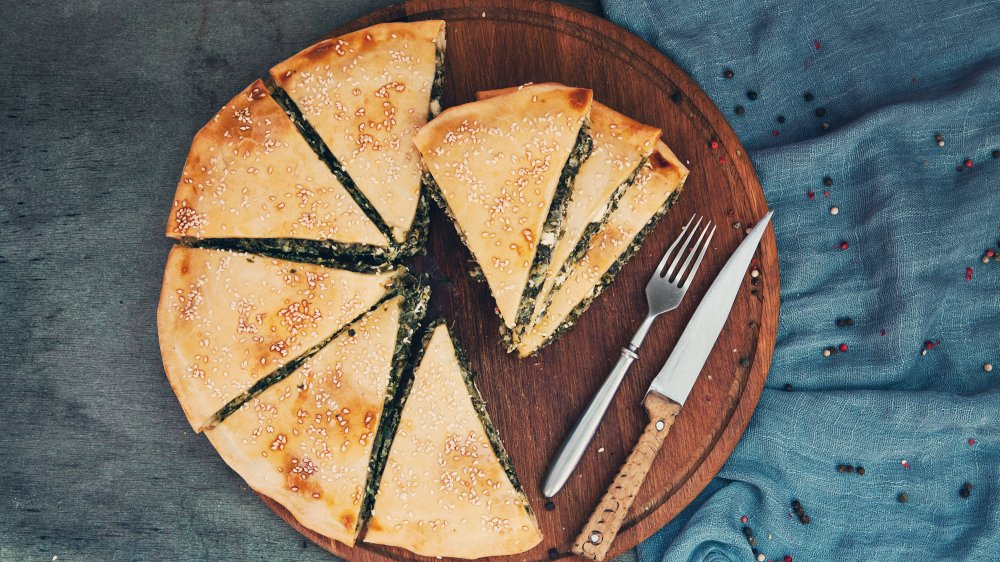 Greek pie spanakopita on deep blue background.