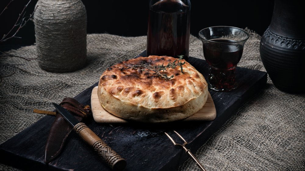 Still life in a dark key on a medieval theme. medieval homemade cheese pie recipe
