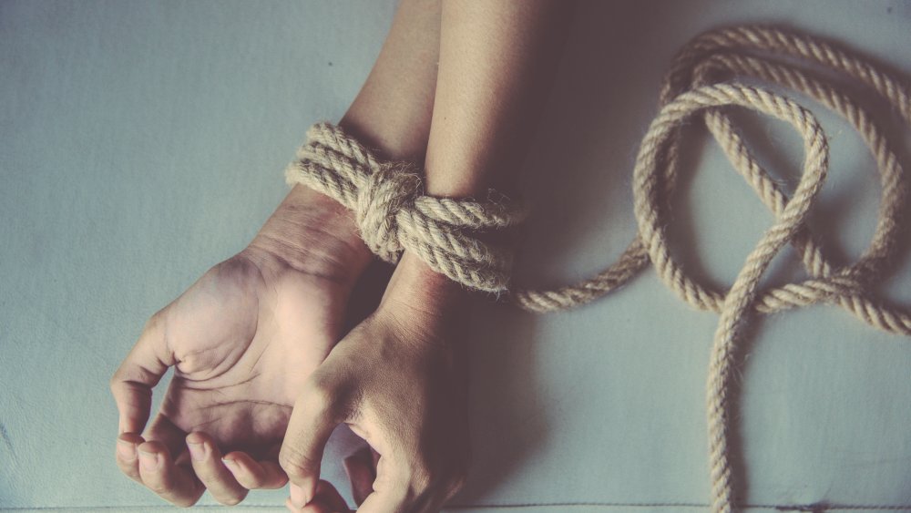 Wrists bound with rope