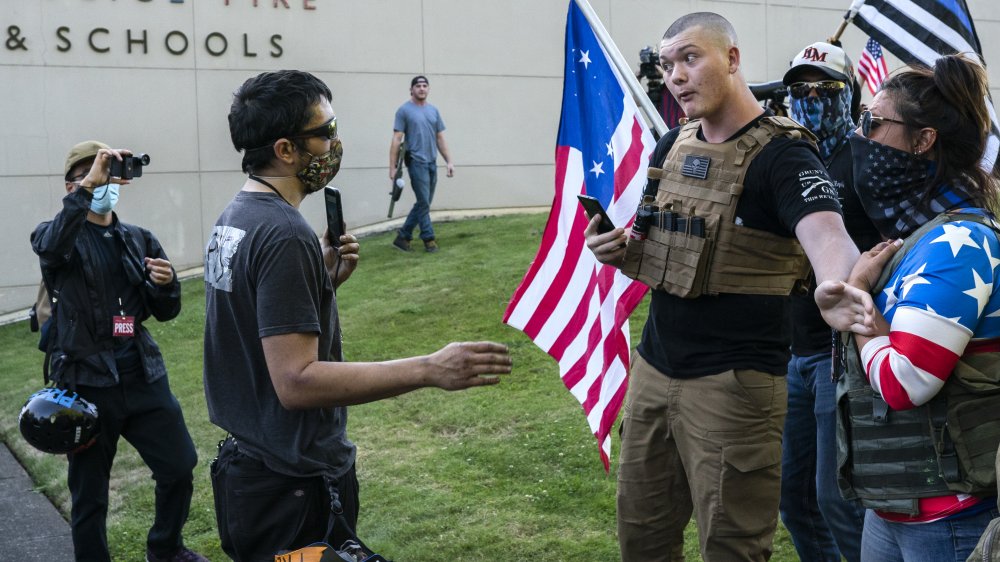 Far right and Black Lives Matter protesters argue during a rally at Gresham City Hall on August 26, 2020 in Gresham, Oregon. Far right and left protesters gathered Wednesday after a decision by the city government of the Portland suburb to fly a Black Lives Matter flag. 
