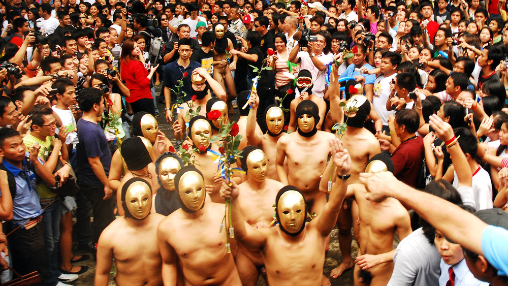 University fraternity members run masked and nude at the 2010 Annual Oblation Run in the Philippines 