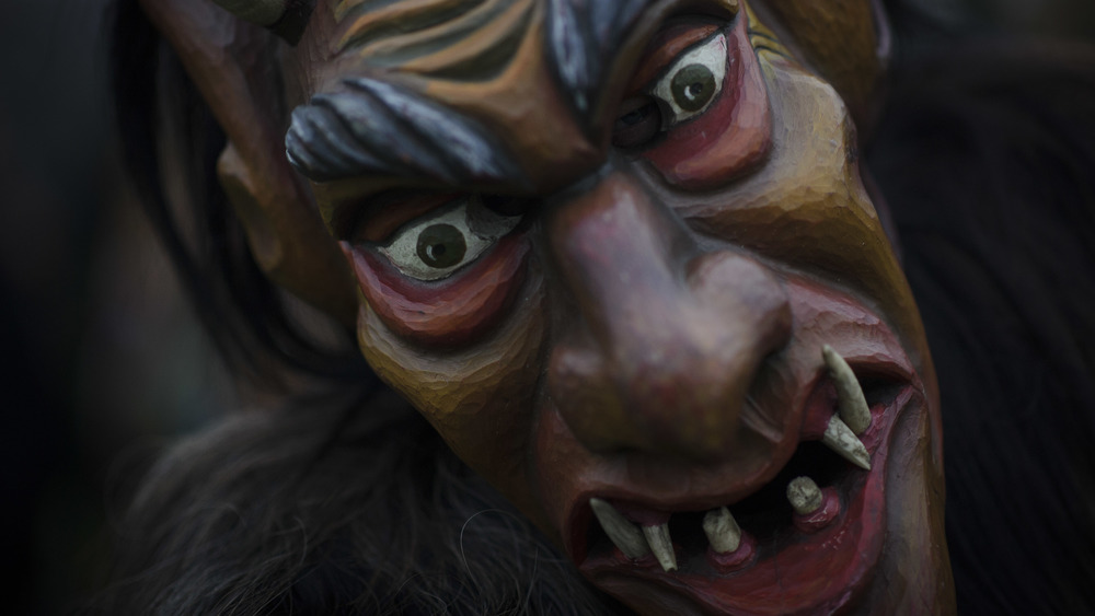 A festival-goer dressed as a Perchten, or ugly follower of Perchta