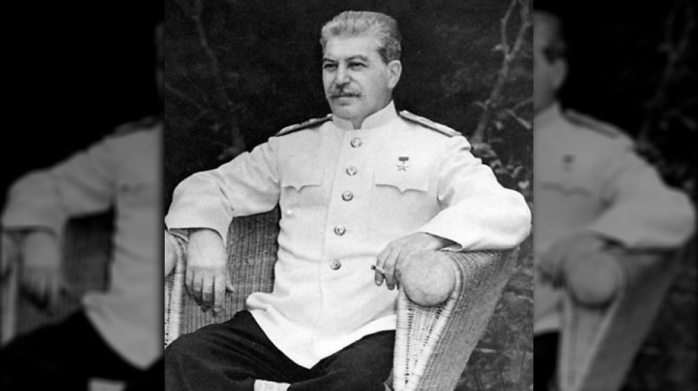 Joseph Stalin, seated outdoors at Berlin conference