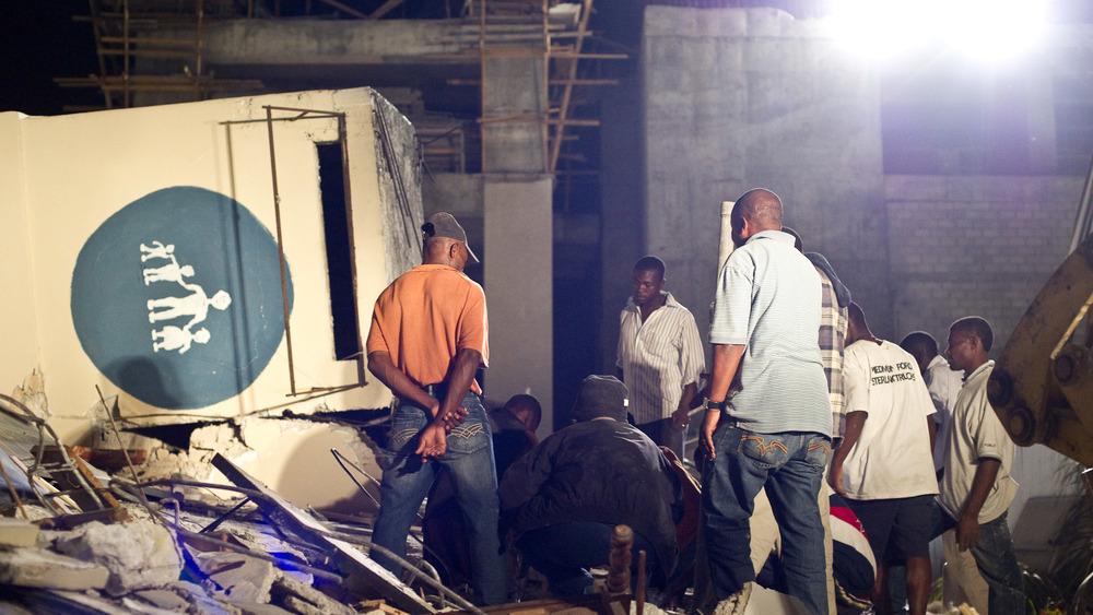 JANUARY 13: People search for survivors amongst the ruins of the childrens hospital, following a major earthquake on January 13, 2010 in Port-au-Prince, Haiti. 