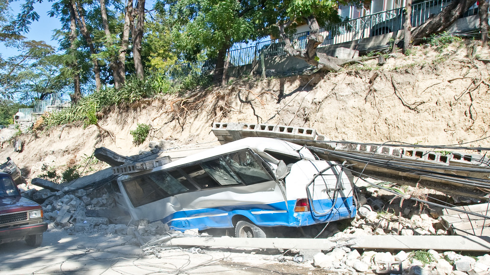 JANUARY 14: A bus is crushed beneath a wall that fell upon it, January 14, 2010 in Port-au-Prince, Haiti. All passengers on board managed to escape a few hours later. 