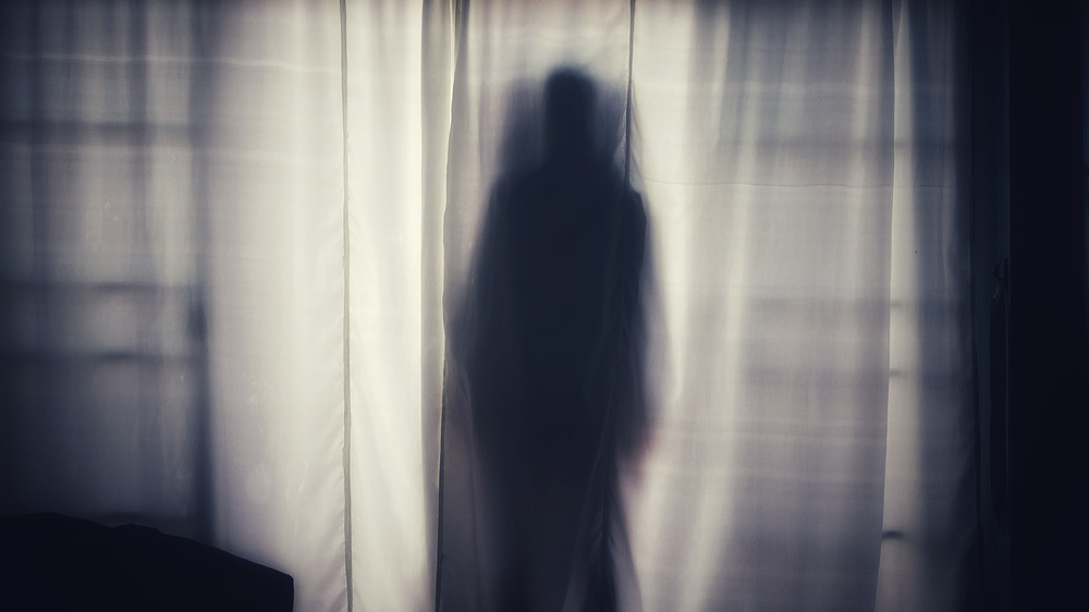 Ghostly figure behind a curtain
