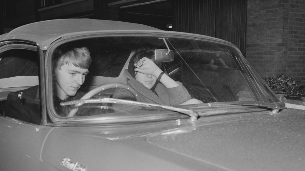 Guinness heir Tara Browne with his fiancee Noreen MacSherry in a car, 1963