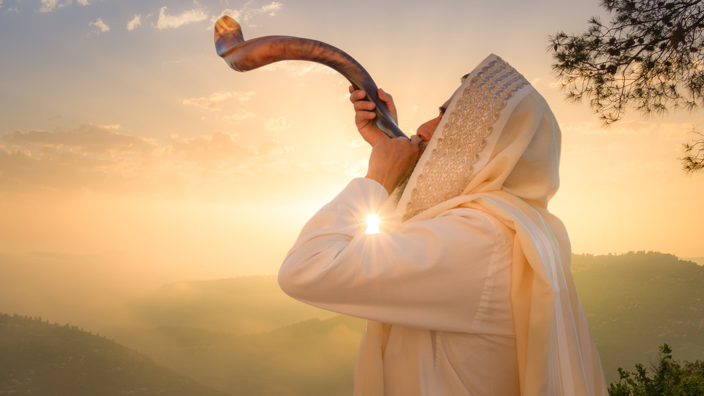 man sounding horn