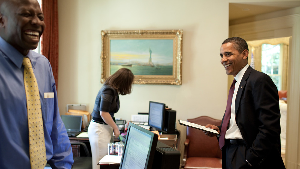President Barack Obama laughing with his aide Reggie Love 