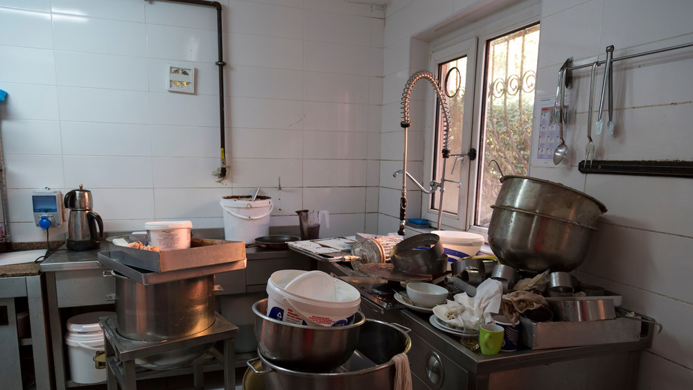 Photo of a dirty commercial kitchen.