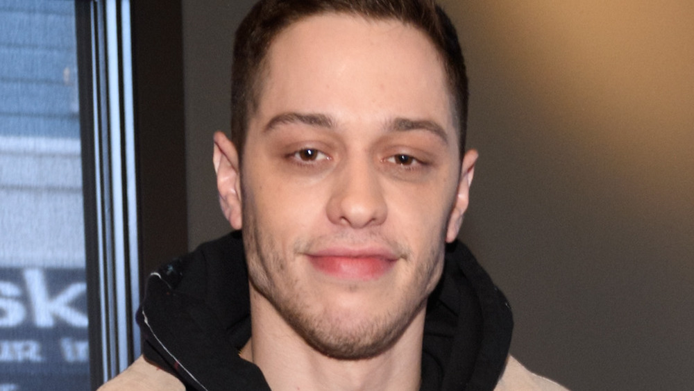 Pete Davidson smirking