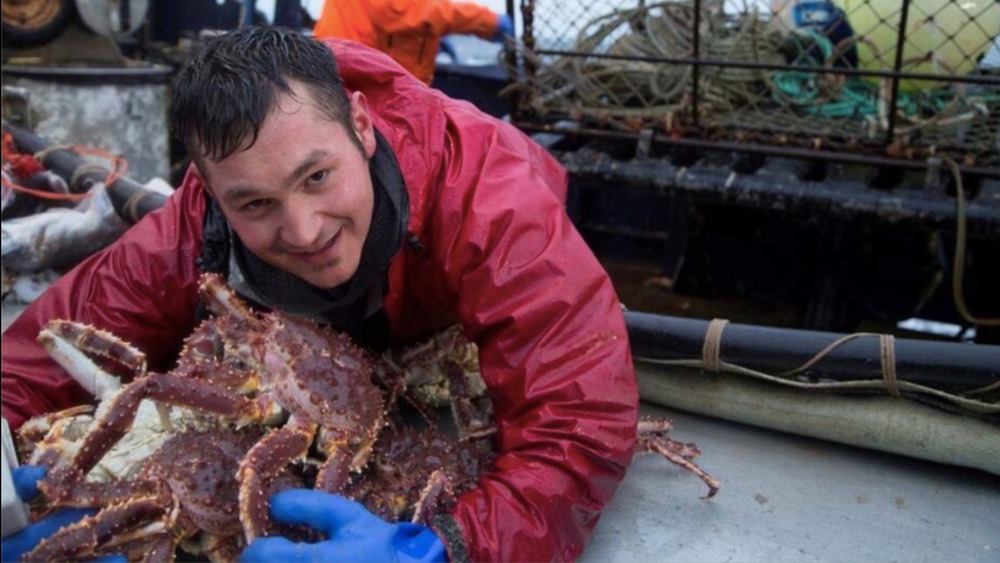 Nick McGlashan hugging crabs