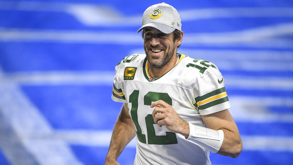 Aaron Rodgers running and smiling