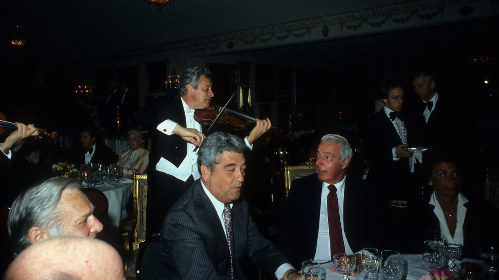 Joe DiMaggio sits at dinner