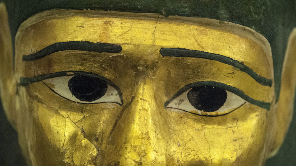 Ancient Egyptian mummy mask with gold