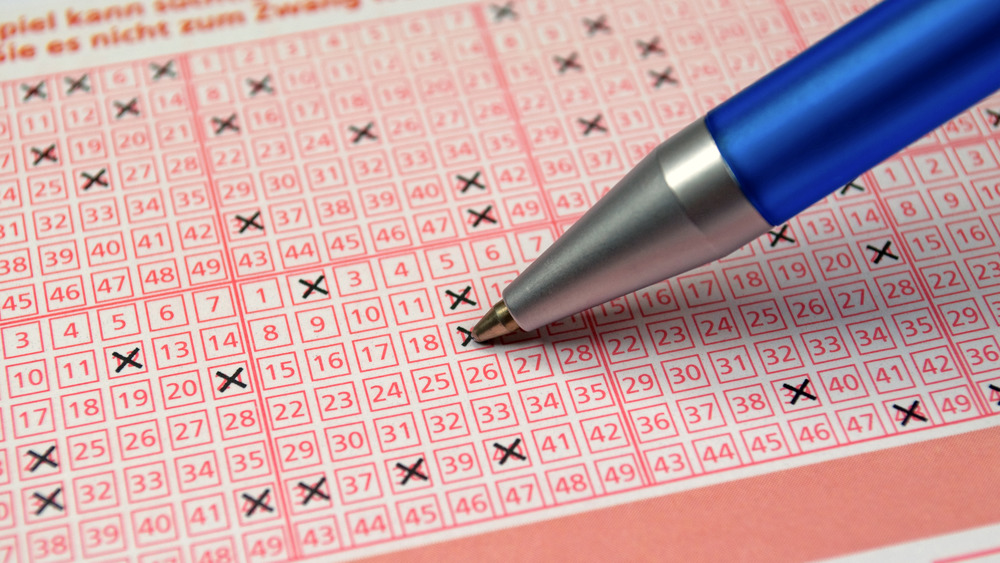 Pen filling out lottery ticket