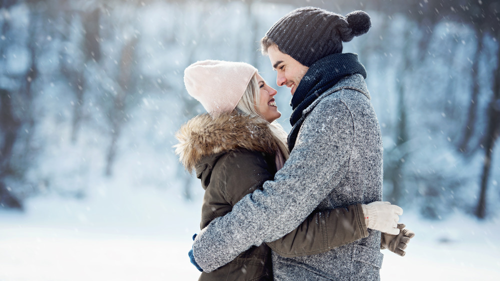 A photograph of a young couple in the snow.